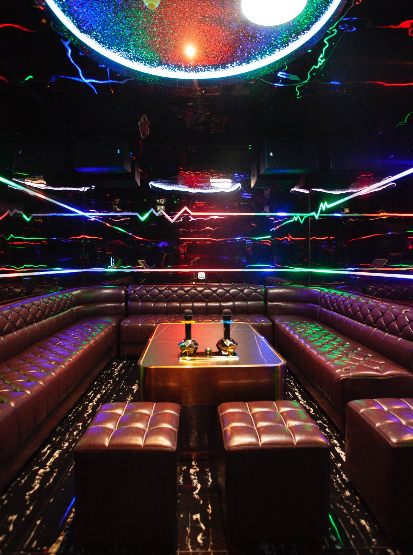 Private karaoke room K6 with premium bar service and theatrical neon lighting