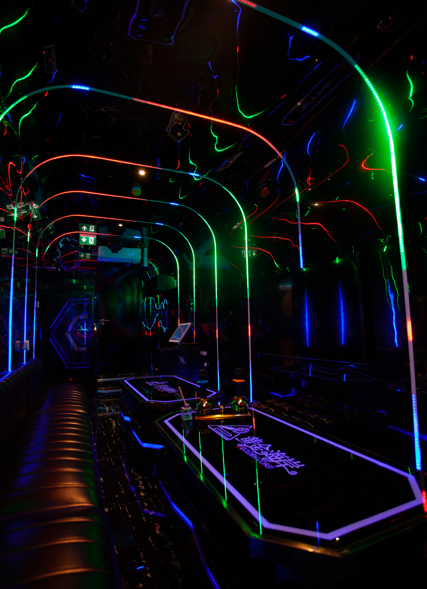 Private karaoke room K1 with hot pink neon decor and velvet seating
